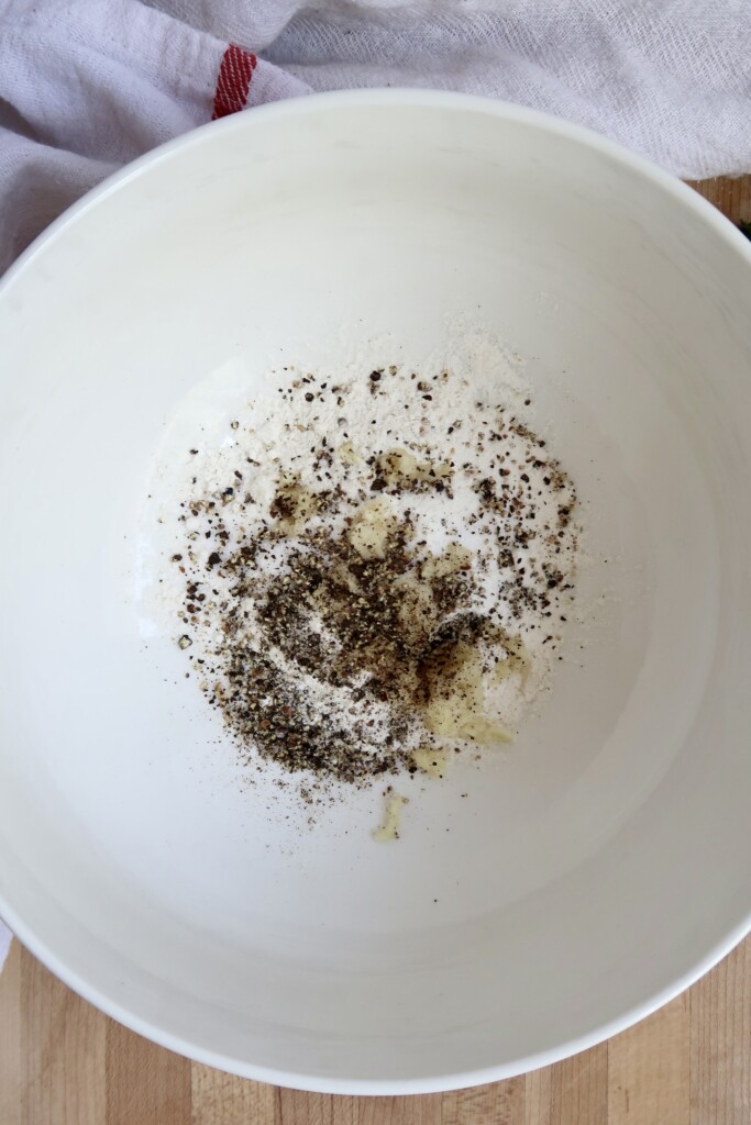 Bowl with flour with garlic, black pepper and spices.