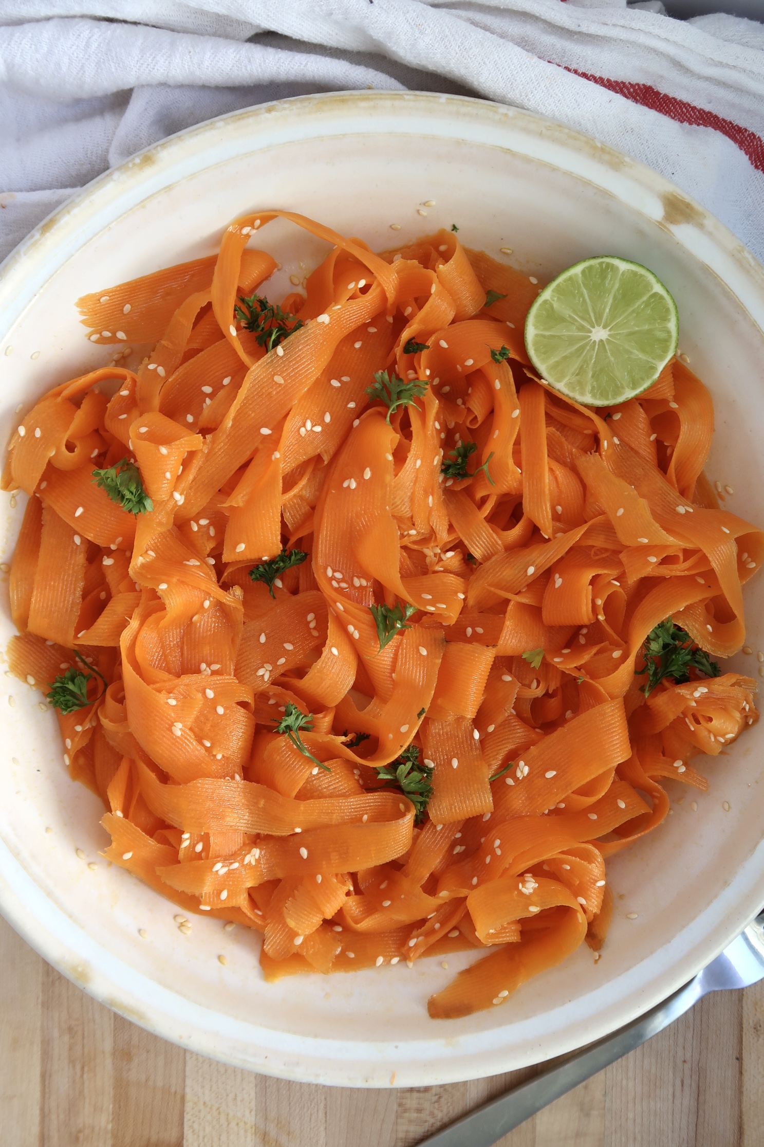 Shaved carrot salad with parsley and lime to garnish.