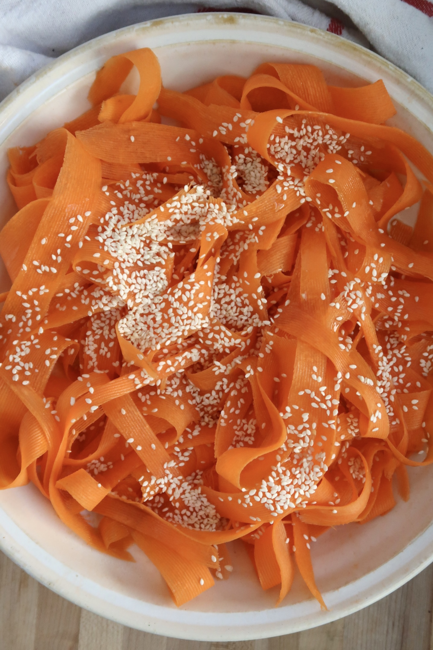 Shaved carrots with sesame seeds on them.