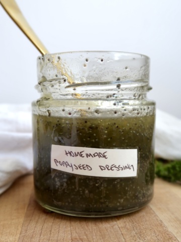 Poppyseed dressing in a jar that's labaled with a spoon in it.