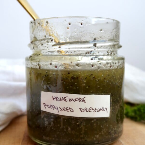 Poppyseed dressing in a jar that's labaled with a spoon in it.