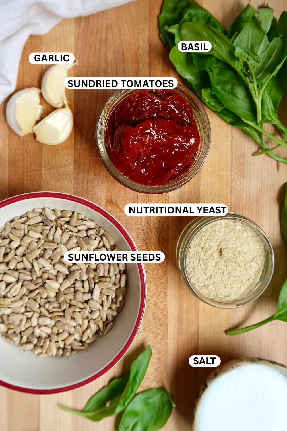 Flatlay of ingredients for sundried tomato pesto.