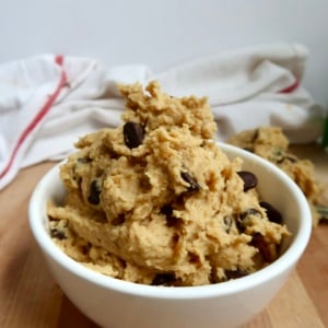 Bowl of chickpea cookie dough with chocolate chips on a white background.