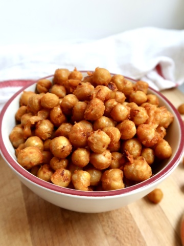 Bowl filled with golden, roasted buffalo chickpeas.