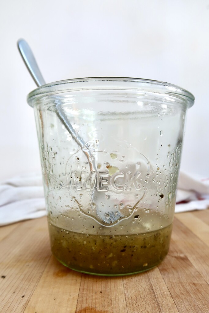 Jar with marinade in it and a fork.