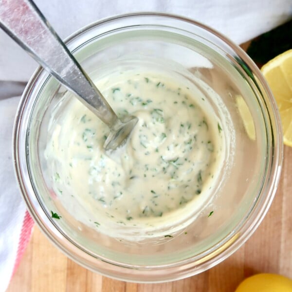 Overhead shot of jar with creamy dressing in it and a spoon.