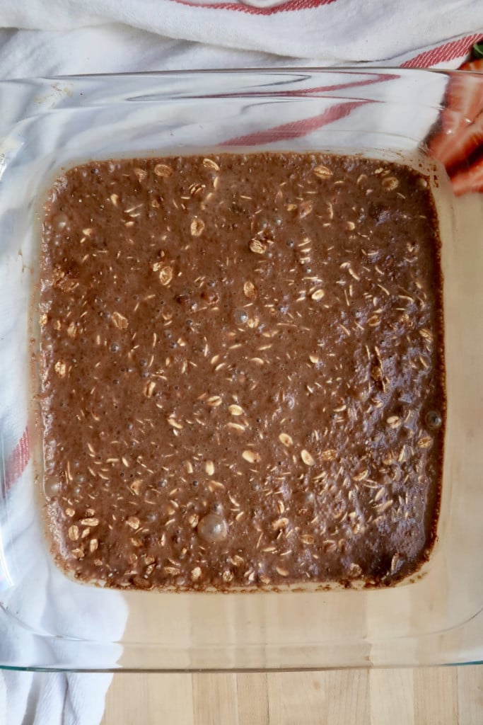 Baking dish with oats, cocoa powder and soy milk mixed it.