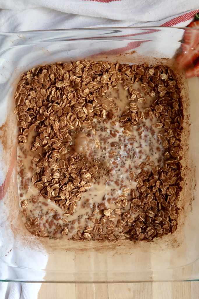 Baking dish with oats, cocoa powder and soy milk mixed it.
