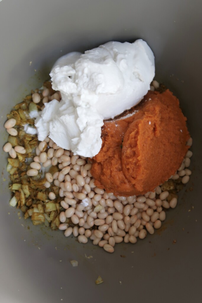 Large pot with beans and pumpkin and coconut and onion.