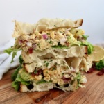 chickpea mash sandwich cut in half and stacked on top of each other.