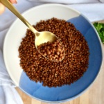 Crispy lentils in a bowl with a spoon scooping some.