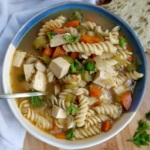 Bowl with soup with tofu, carrot, celery and fusili.