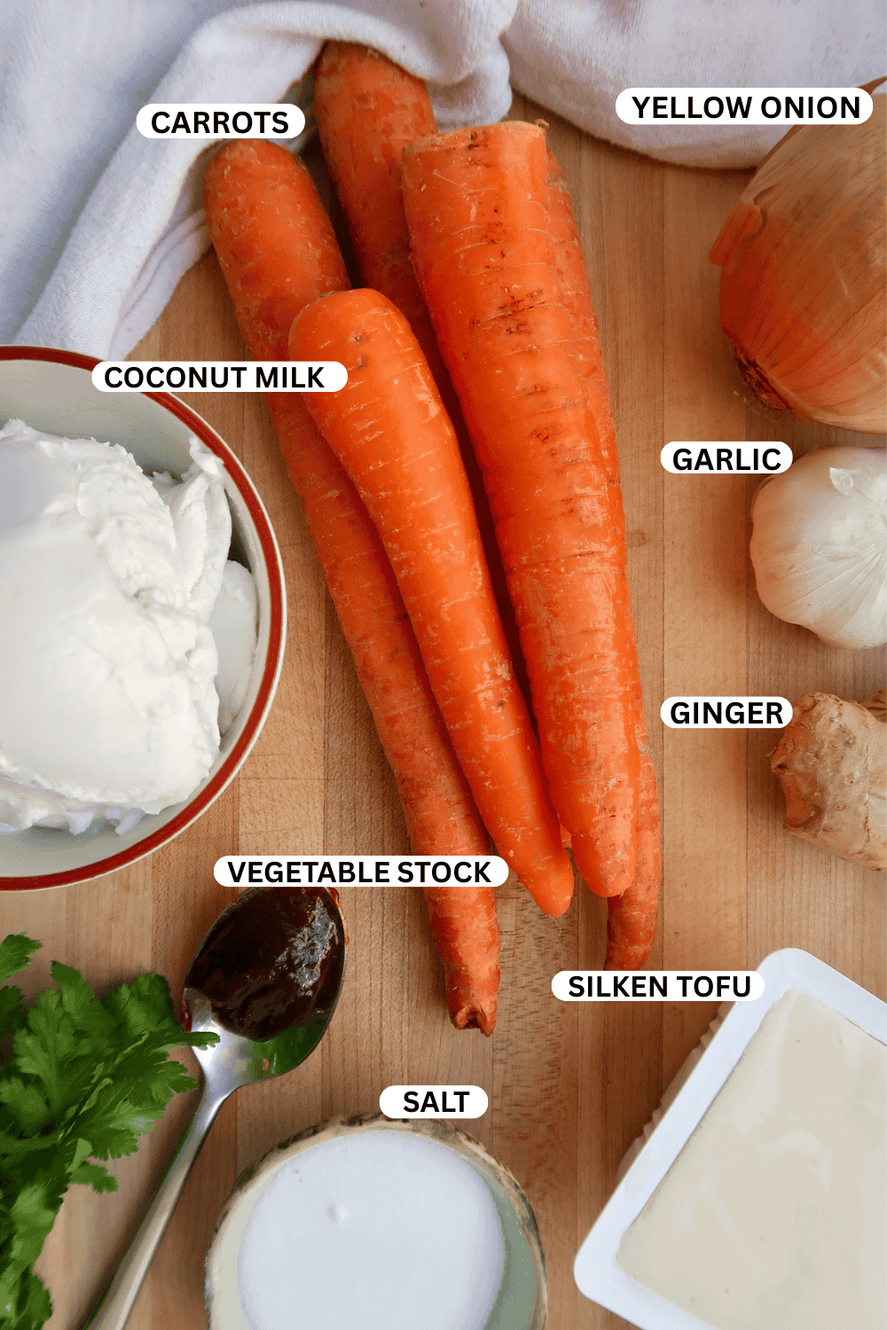 Flatlay of ingredients for carrot ginger soup.