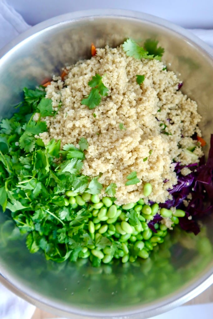 Large bowl with cooked quinoa, edamame, cabbage and cilantro.