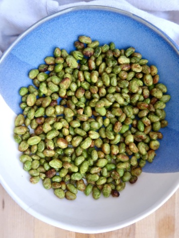 Bowl with roasted edamame inside.