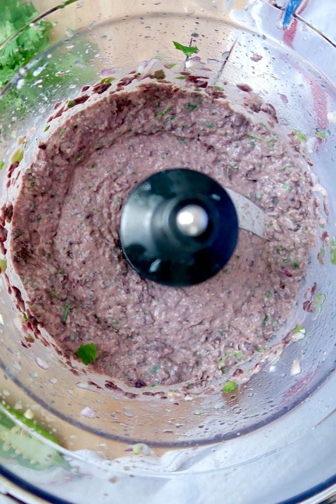 Blended black bean dip in a food processor.